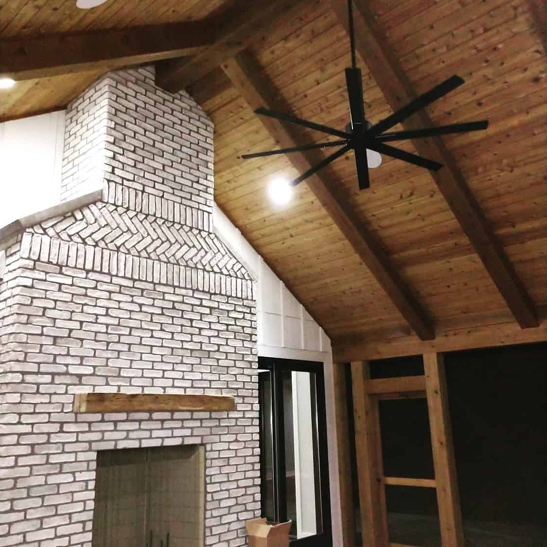 custom decorative ceiling in living room with wooden beams.