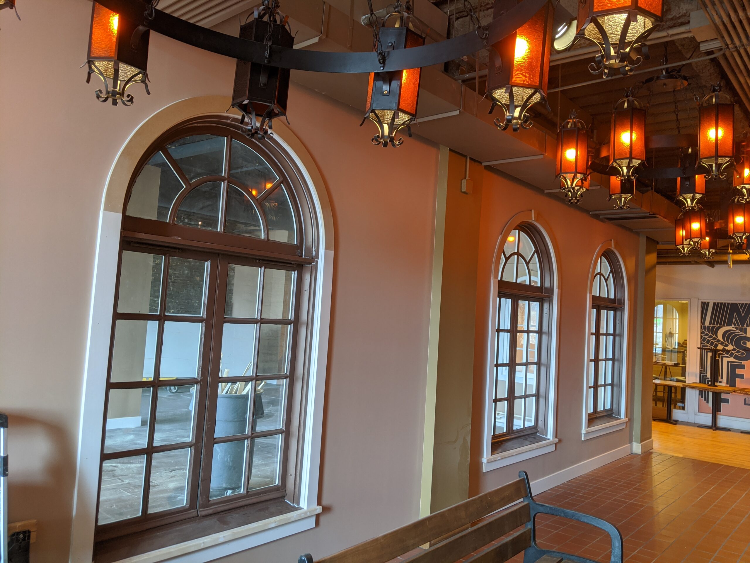 Custom arched windows with dark wood trim installation