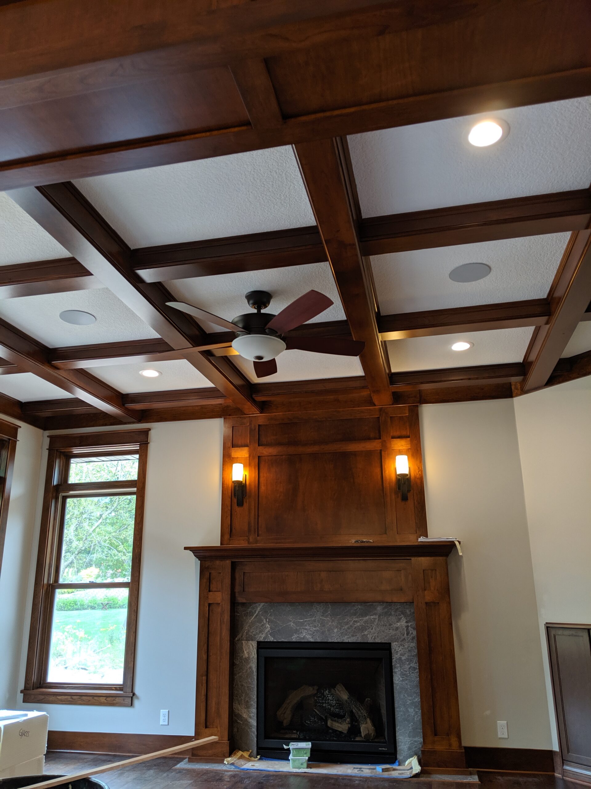 Walnut wall paneling and built-in fireplace surround